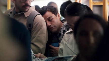 Oscar Isaac as Marc Spector/Steven Grant sleeping on the shoulder of a stranger in Moon Knight