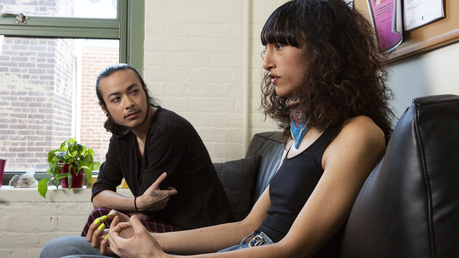 A transgender couple sit together.