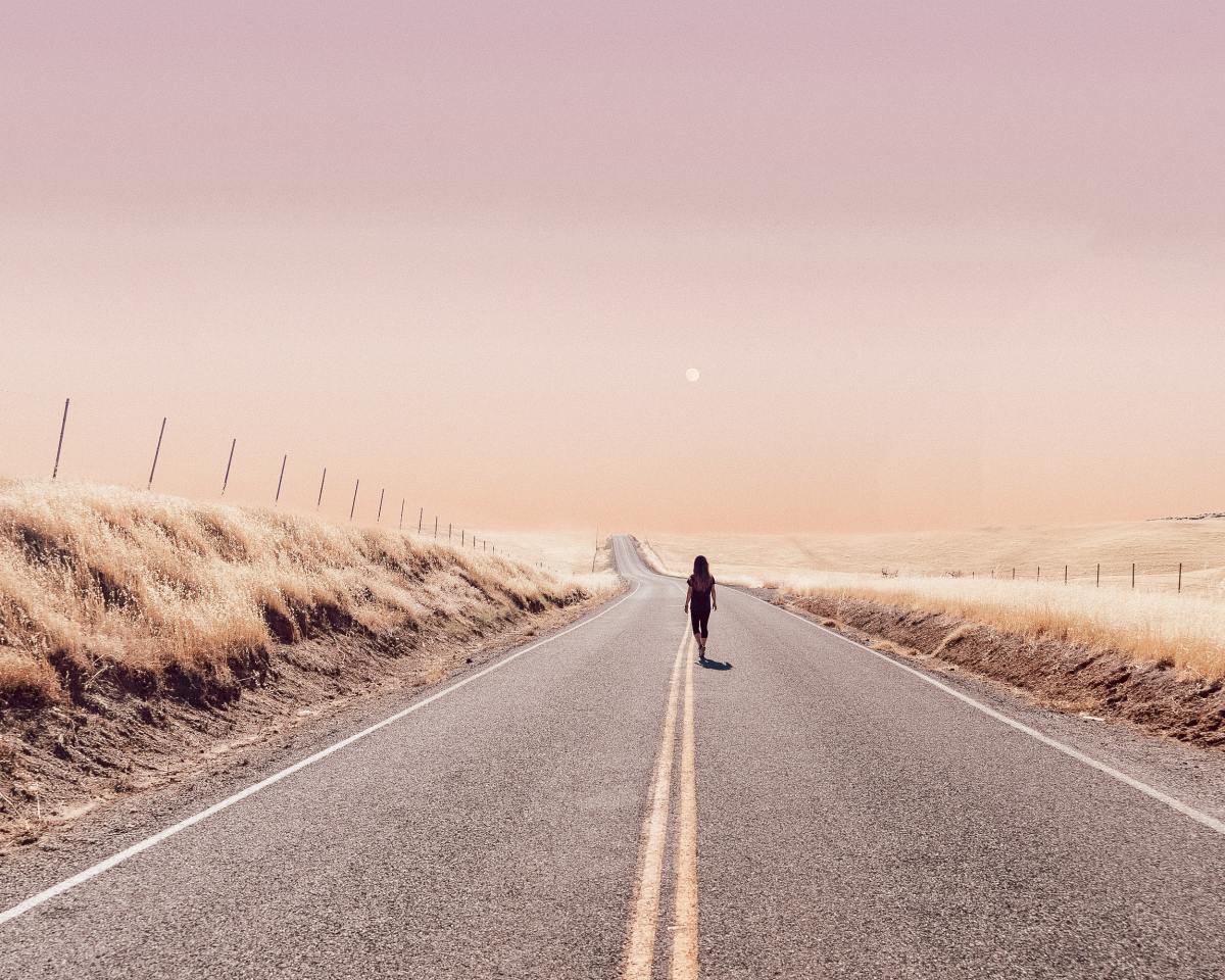 Woman walks down road 