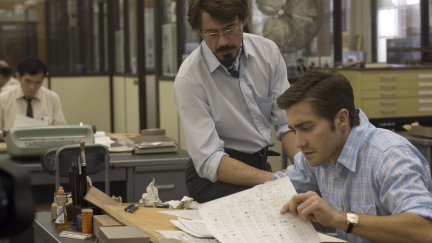 Robert Downey Jr. and Jake Gyllenhaal looking at papers in Zodiac