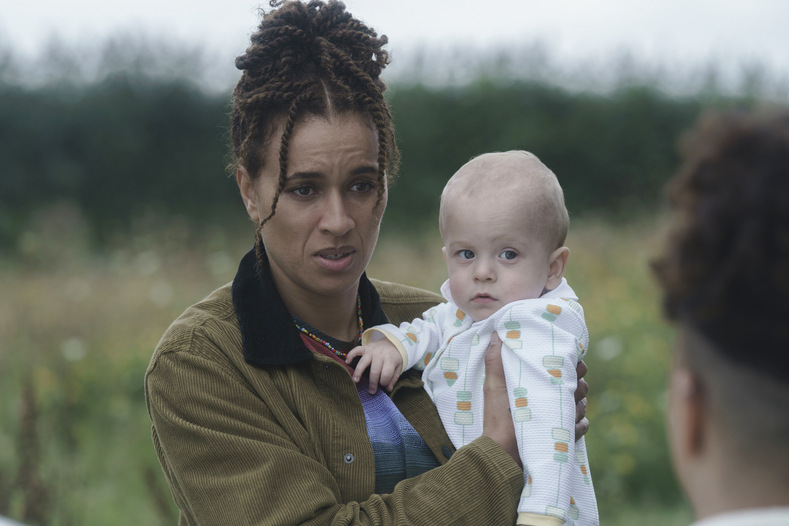 The Baby trailer screencap of a woman holding a baby.