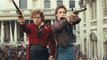 Aaron Tveit and Eddie Redmayne in Les Mis holding guns