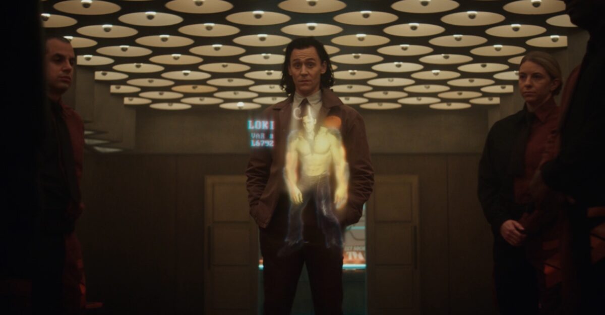 Loki looks at a hologram of a muscular, monster varian of himself.