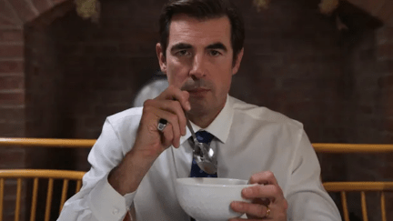 A handsome white man (JP) holds a bowl and a spoon, staring into the camera directly in front of him.