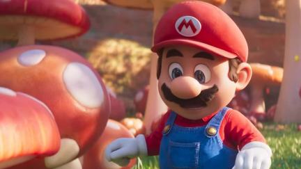 Mario, in the 2023 Super Mario Bros. Movie, looks at Toad in a mushroom patch.