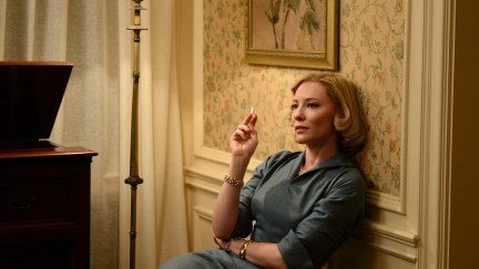 Cate Blanchett smoking a cigarette in a wallpapered room in 'Carol'