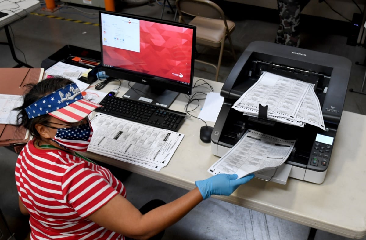 NORTH LAS VEGAS, NEVADA - OCTOBER 20: A Clark County election worker scans mail-in ballots at the Clark County Election Department on October 20, 2020 in North Las Vegas, Nevada. In-person early voting for the general election in the battleground state began on October 17 and continues through October 30. Earlier this year, Nevada Gov. Steve Sisolak signed a bill mandating that all registered voters in the state receive a mail-in ballot for the first time to help keep people safe from the coronavirus (COVID-19). (Photo by Ethan Miller/Getty Images)