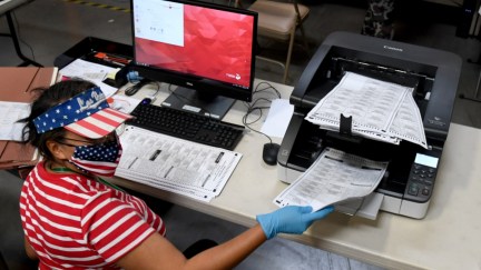 NORTH LAS VEGAS, NEVADA - OCTOBER 20: A Clark County election worker scans mail-in ballots at the Clark County Election Department on October 20, 2020 in North Las Vegas, Nevada. In-person early voting for the general election in the battleground state began on October 17 and continues through October 30. Earlier this year, Nevada Gov. Steve Sisolak signed a bill mandating that all registered voters in the state receive a mail-in ballot for the first time to help keep people safe from the coronavirus (COVID-19). (Photo by Ethan Miller/Getty Images)