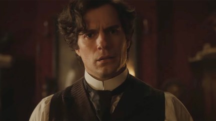 Henry Cavill as Sherlock looking at a puzzle in Enola Holmes 2