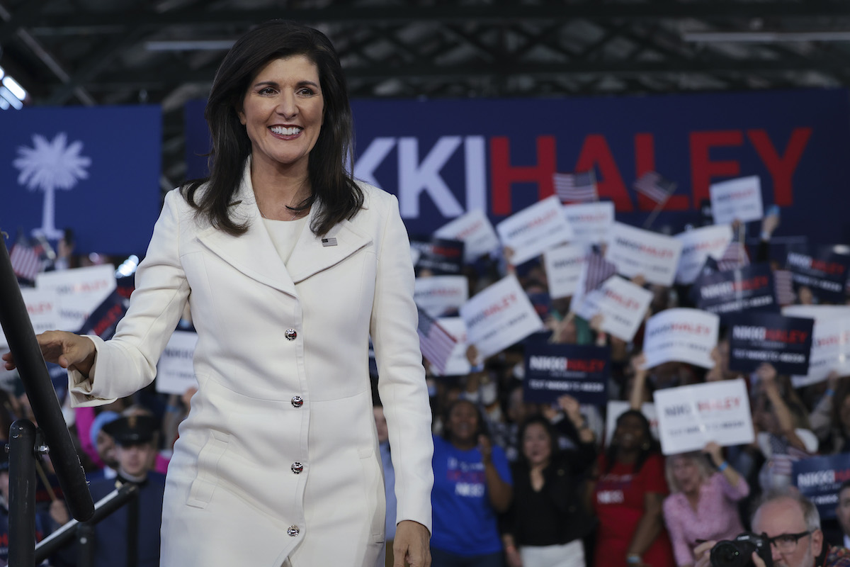 Nikki Haley grins in front of a crown of supporters.