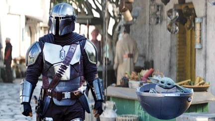 Pedro Pascal as Din Djarin with Grogu on Nevarro in The Mandalorian