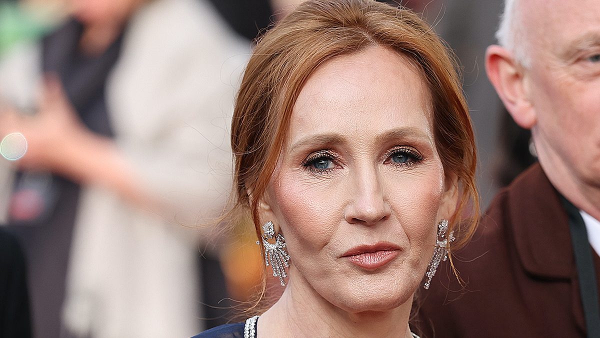 JK Rowling purses her lips and looks stern on a red carpet.