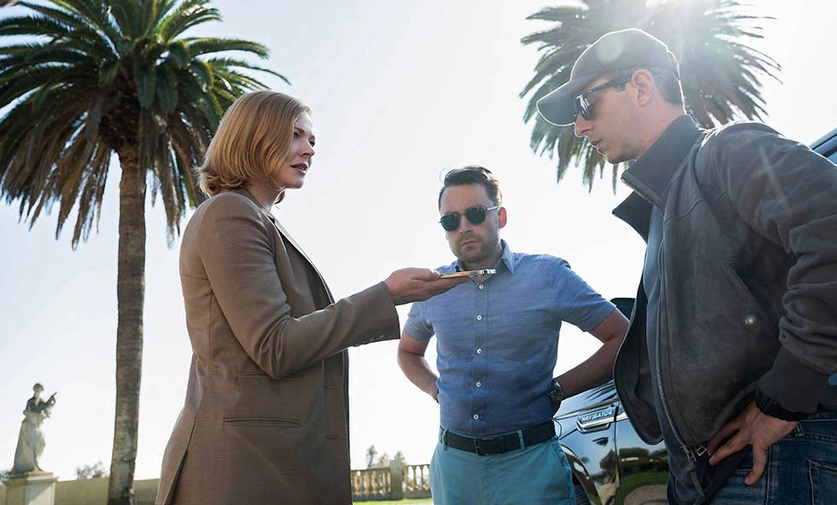 Shiv (Sarah Snook) holding a phone to her brothers Kendall (Jeremy Strong) and Roman (Kieran Culkin) on Succession