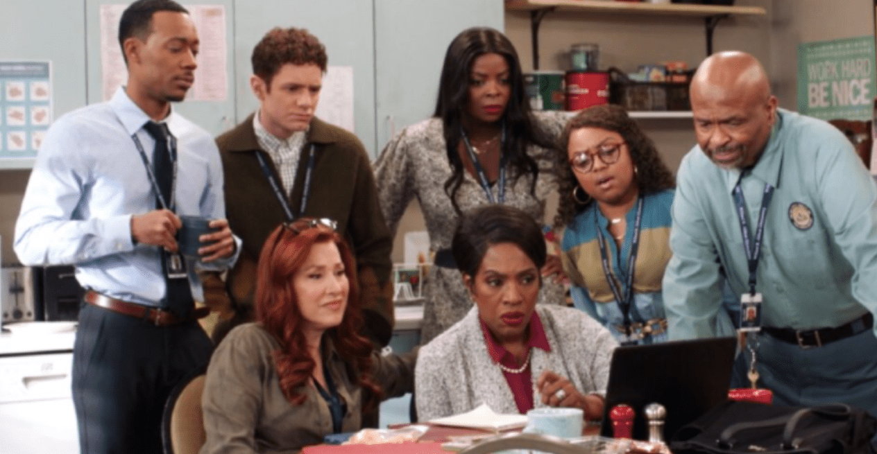 The cast of 'Abbott Elementary' stare at a laptop