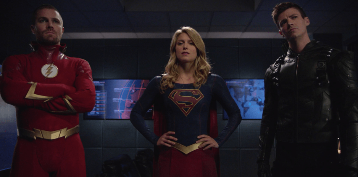 The Flash, Green Arrow, and Supergirl stand together