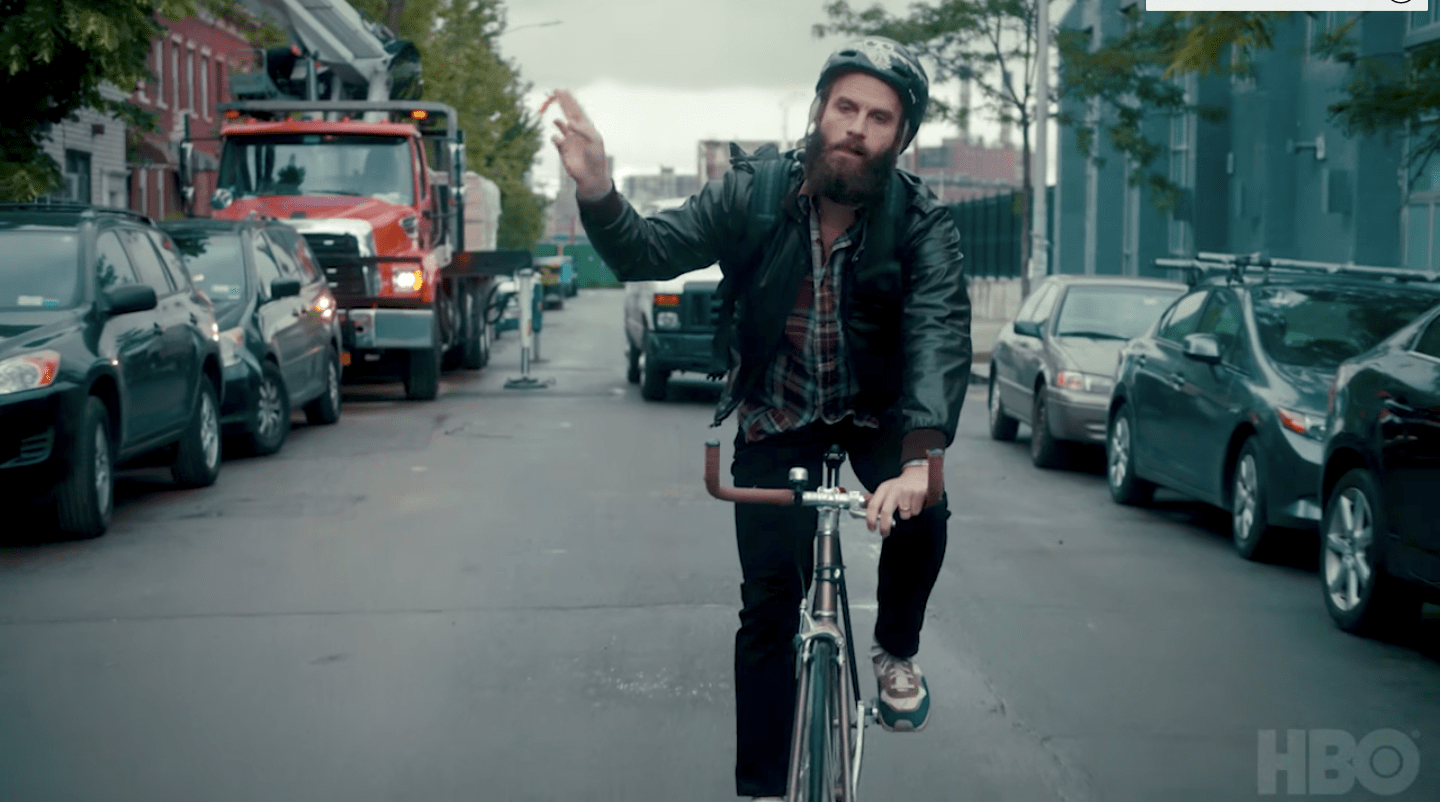 The Guy cycling down a NYC street.