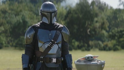 Din Djarin (Pedro Pascal) and Grogu watching Bo-Katan fight