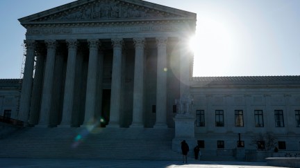 The sun rises behind the Supreme Court building.