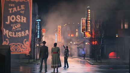 Josh and Melissa standing in front of a sign in Schmigadoon season 2