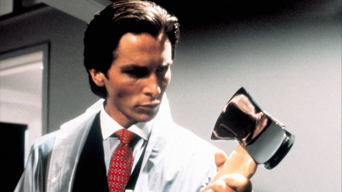 A wall street business man wrapped in plastic contemplates an axe in "American Psycho"