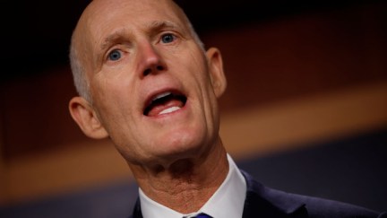 Florida Senator Rick Scott with his big, ignorant mouth wide open, spewing hate.