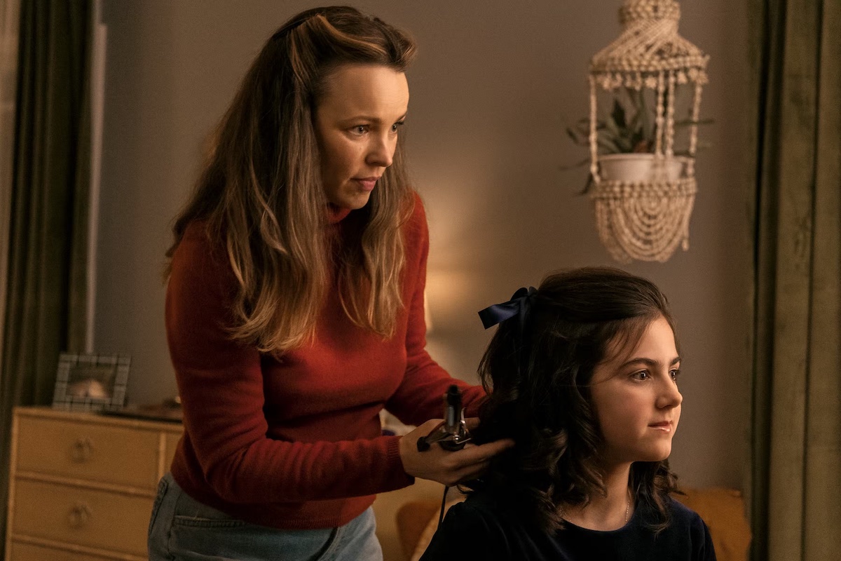 Barbara helps Margaret with her hair, standing behind her.