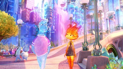 A scene from Pixar's animated film, 'Elemental.' Wade, a male-coded water element walks down a street alongside Ember, a female-coded fire element. They look at each other lovingly.