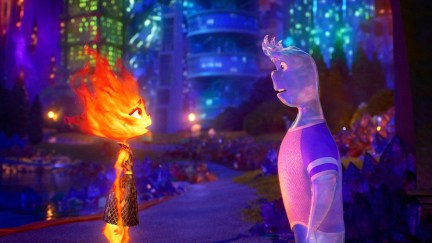 Ember and Wade stare at each other with an evening city skyline behind them in 'Elemental.'