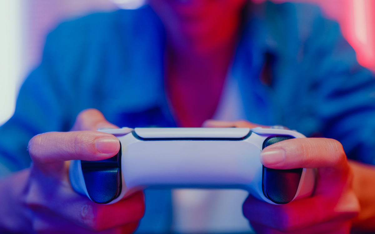 Closeup of hands holding a video game controller.