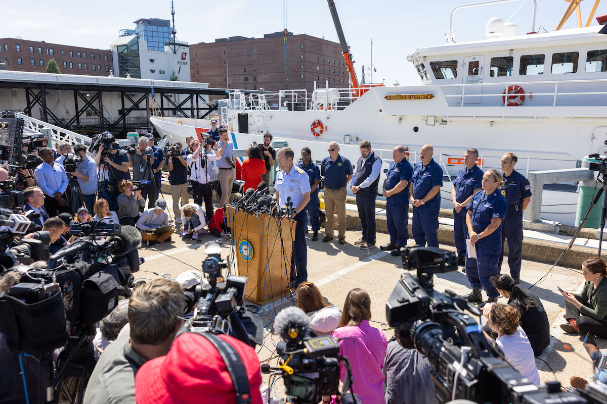 A news conference on the deck of a ship.