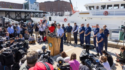 A news conference on the deck of a ship.