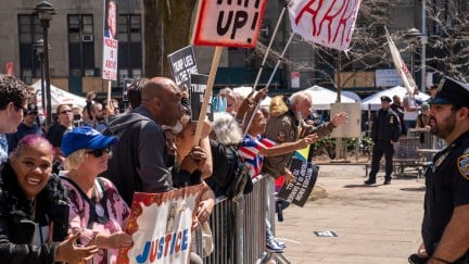 New York Police Department officials, right, separate critics and supporters of U.S. President Donald Trump before his arraignment