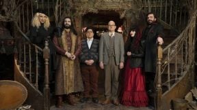 The cast of What We Do in the Shadows stands in the foyer of their mansion.