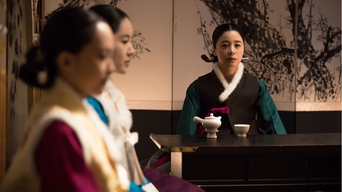 Three women in traditional Korean dress sit around a table in "The Wrath" 