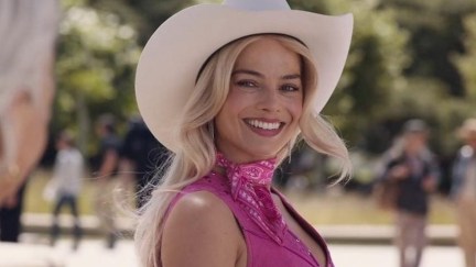 Margot Robbie smiles, dressed as Cowgirl Barbie.