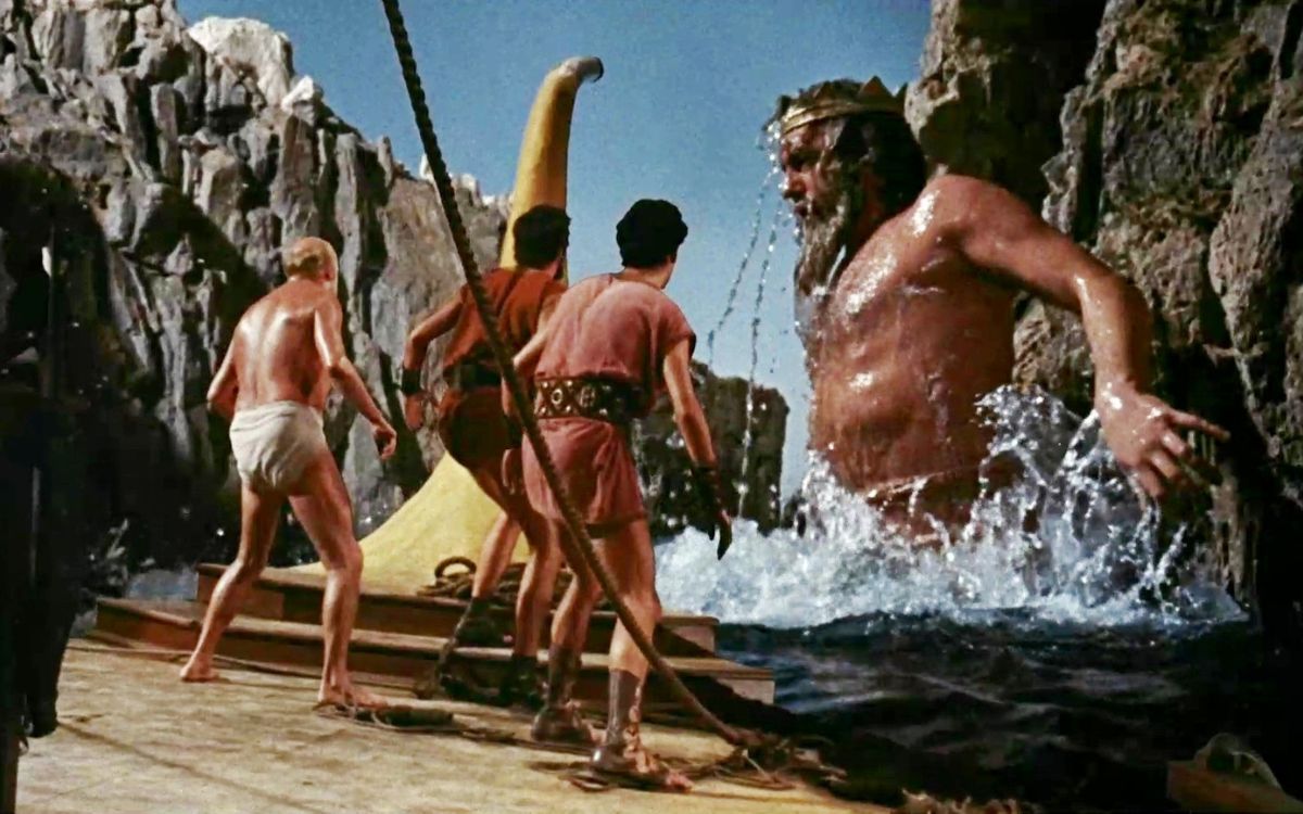 A giant man wearing a crown emerges from the sea while other men prepare to fight him in "Jason and the Argonauts"