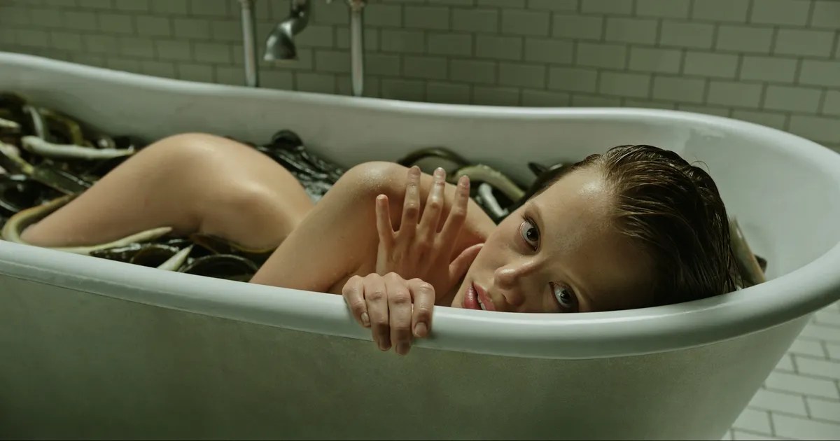 Mia Goth taking a snake bath in "A Cure For Wellness"