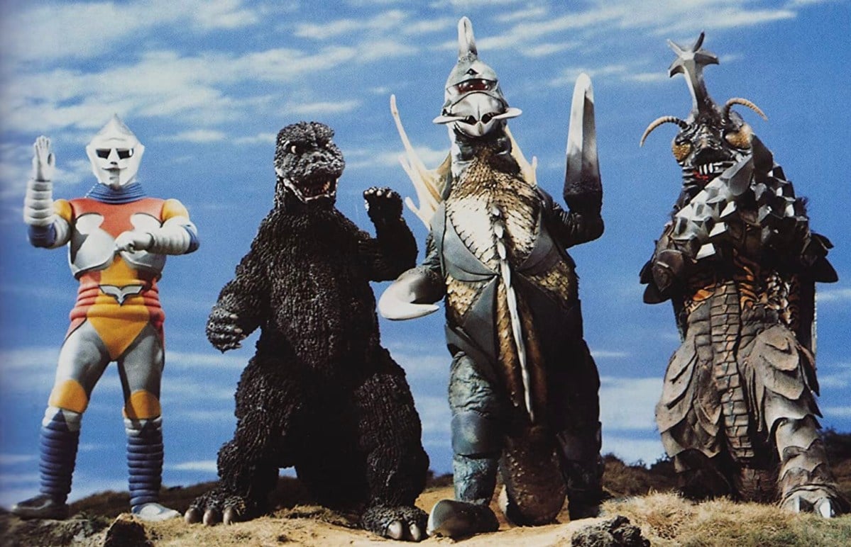 Still from Godzilla vs Megalon; Standing in a line the robot Jet Jaguar, Godzilla, Gigan, and Megalon.