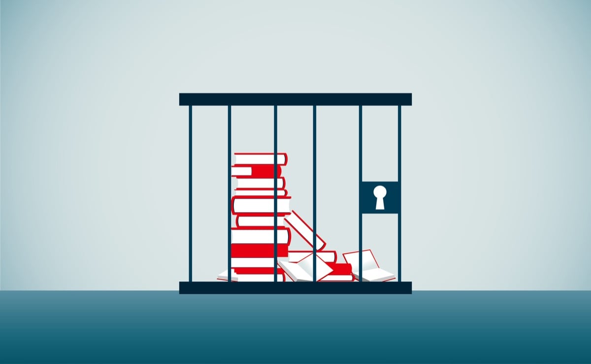 A stack of books locked up in a jail cell 