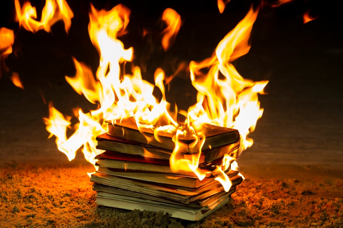 A pile of books, engulfed in flames.