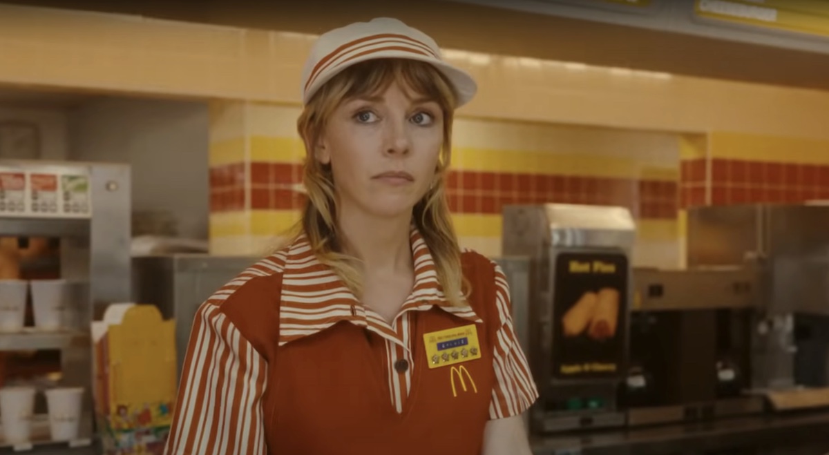 Sylvie (Sophia Di Martino) stands behind a counter, wearing a McDonald's uniform in 'Loki' season 2