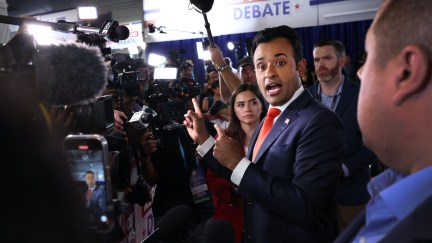 Vivek Ramaswamy speaks animatedly to reporters.