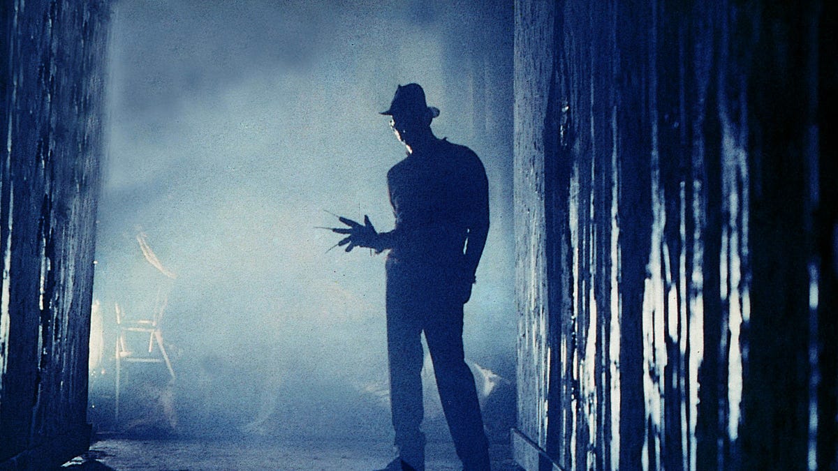 A razor gloved man stands menacingly in an alley in "A Nightmare on Elm Street"