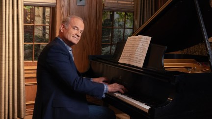 Kelsey Grammer as Frasier Crane sitting behind a piano in the Frasier reboot