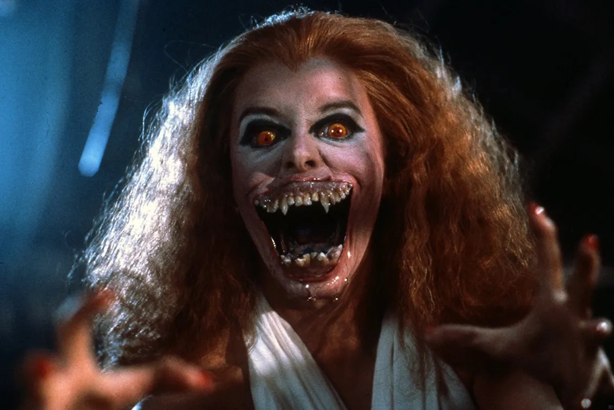 A vampire woman leers with a fanged maw open in "Fright Night" 