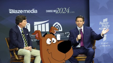 Ron DeSantis and Tucker Carlson speaking at an event. The cartoon dog Scooby-Doo is edited into the photo.