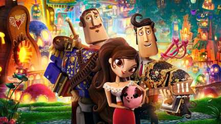 A trio of three animated puppets stand in front of a festival in 'The Book of Life.'