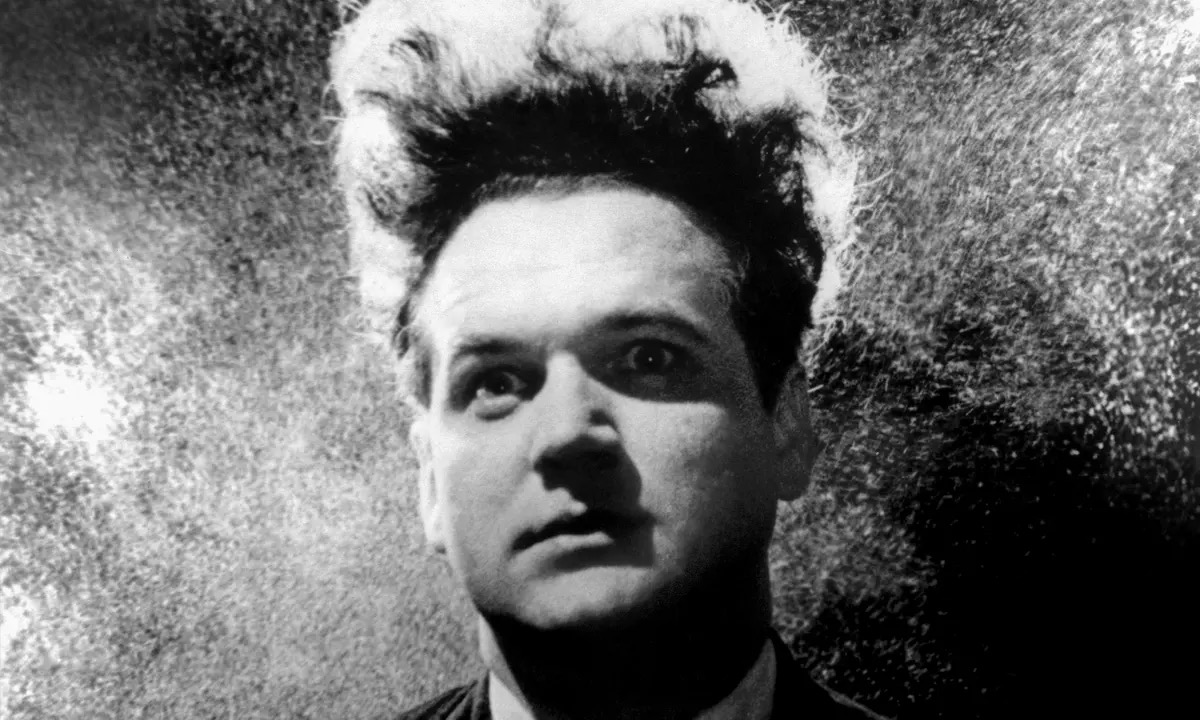 A man looks fearfully at something offscreen in "Eraserhead" 