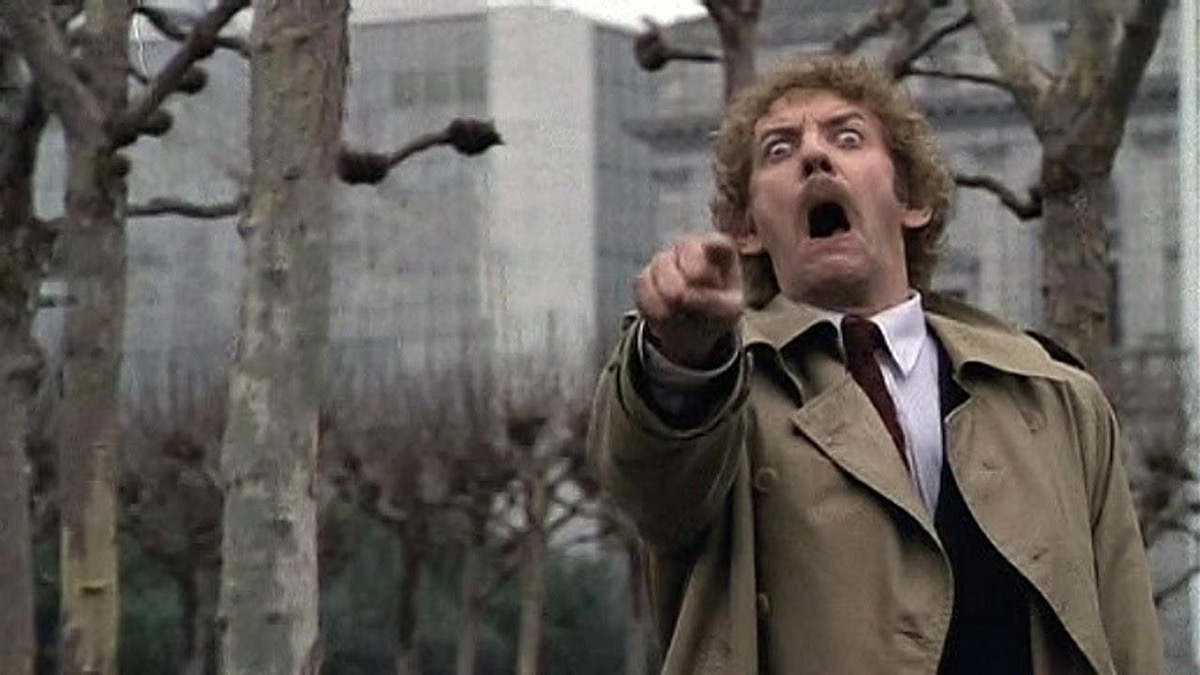 a man in a park points fearfully in "Invasion of the Body Snatchers" 