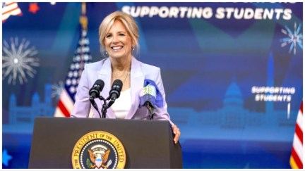 First Lady Jill Biden speaks at a National Education Association event at the White House in July 2023. A sign behind her reads, 